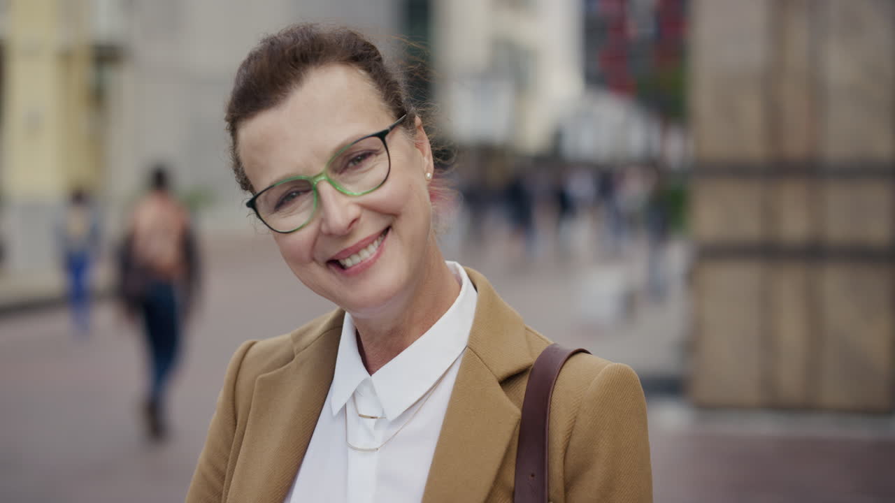 portrait stylish senior business woman smiling happy enjoying professional urban lifestyle successful middle aged female wearing glasses in city real people series
