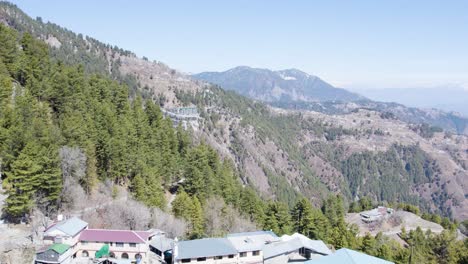 Aerial-view-of-a-village-near-a-national-park-in-Khyber-Pakhtunkhwa-Province,-Pakistan,-nestled-in-mountainous