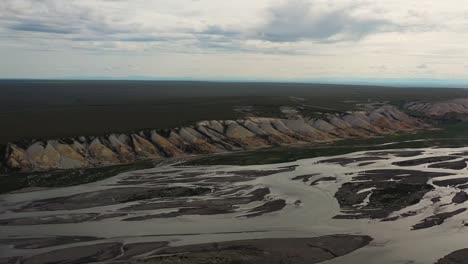 Aerial-flight-over-a-dried-river-in-Alaska-at-sunset