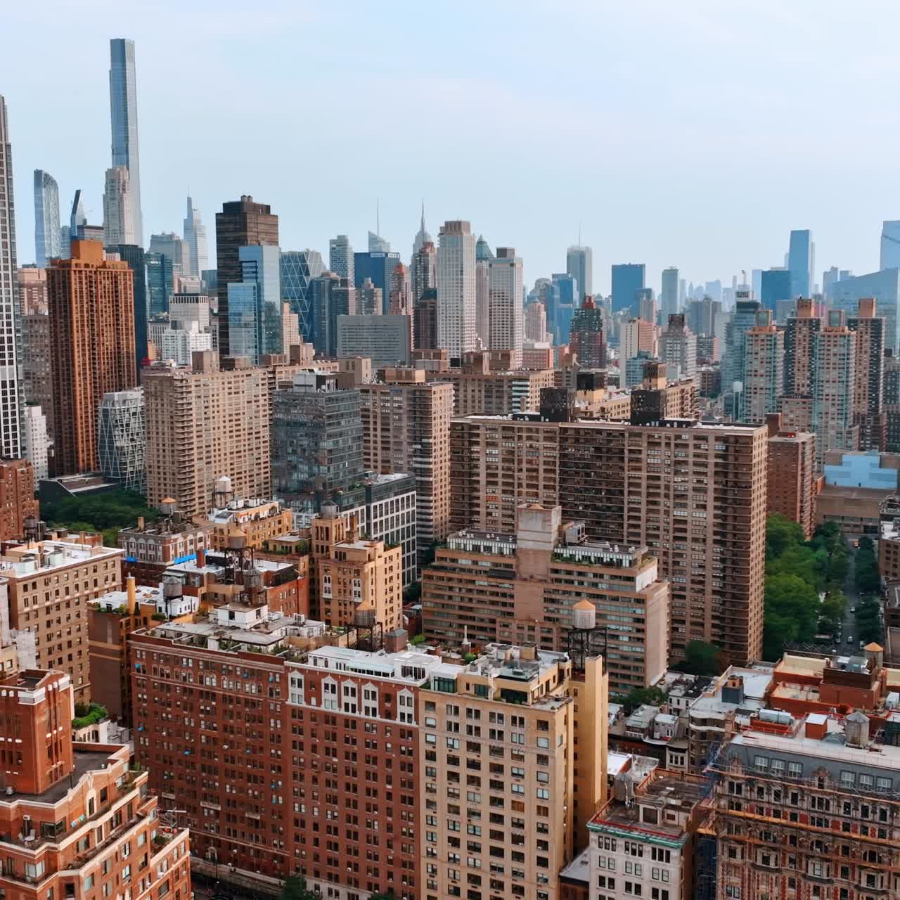 Varied building architecture in the scenery of New York. Multistoried houses at the backdrop of skyscrapers