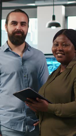 vertical video team of programmers in office automating repetitive tasks using ai scripts