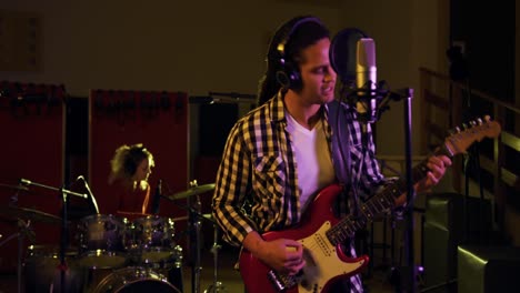 Man-with-dreadlocks-playing-electric-guitar