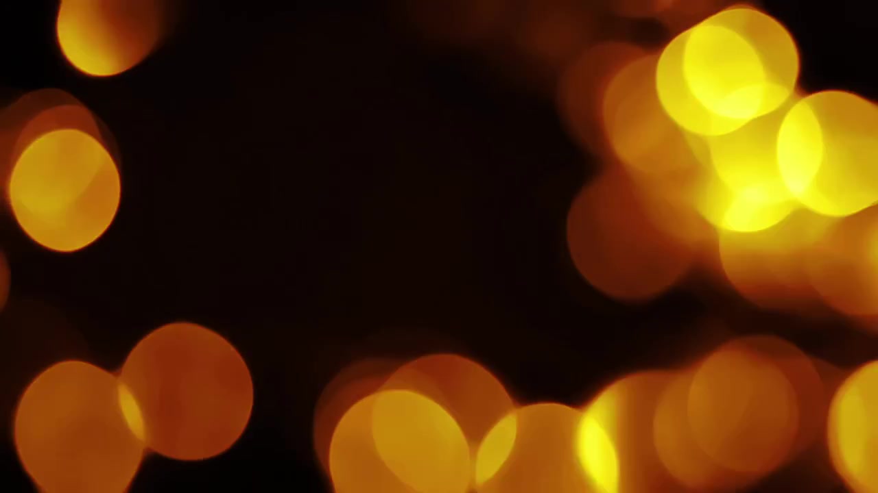 Luci bokeh dorate sfocate che appaiono e svaniscono