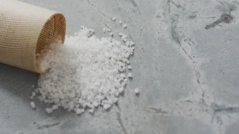 Video-of-pile-of-salt-and-cup-on-stone-kitchen-worktop