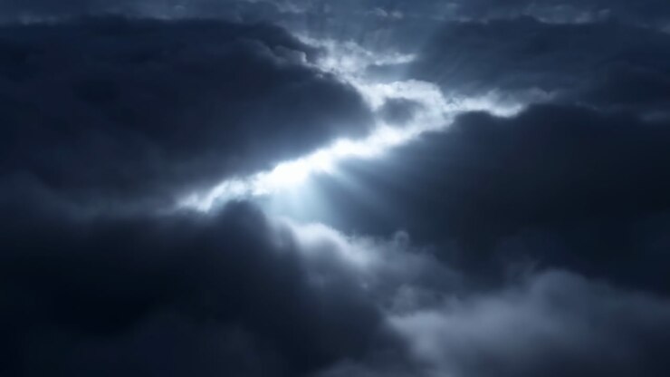 Dramatic Sky With Piercing Light Rays Cutting Through Heavy Clouds, Moody Bluegray Tones And Crepuscular Beams