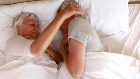 Senior-couple-lying-in-bed