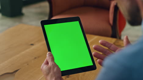 director hand talking mockup tablet office. unknown man gesturing chromakey tab