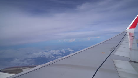 stunning view from airplane window: flying above the clouds