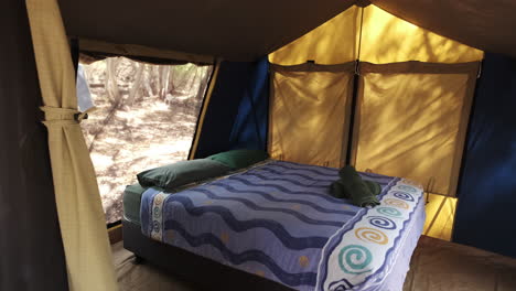 comfortable double bed in a glamping tent