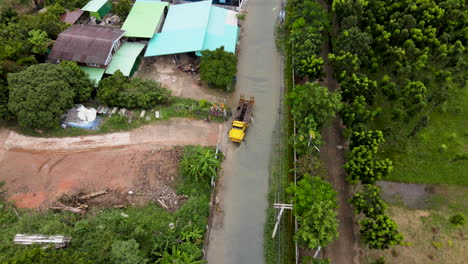 A-yellow-truck-reversing-down-a-flooded-street-after-a-torrential-storm