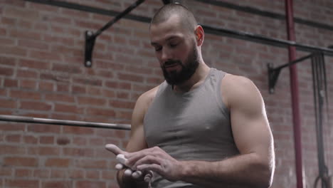man preparing hand for lifting weights