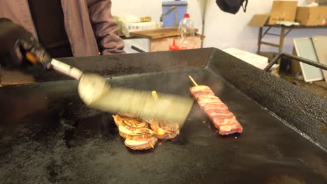 traditional japanese street food grilled barbecue on hot plate in japan.