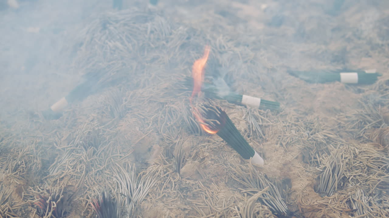 Close up of incense burning on a jokoro at the Senso-ji temple in daylight in Tokyo, Japan