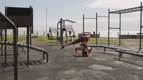 Sporty-Caucasian-woman-exercising-in-an-outdoor-gym-during-daytime