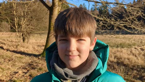 cute boy smiling in a danish forest, portrait of kid