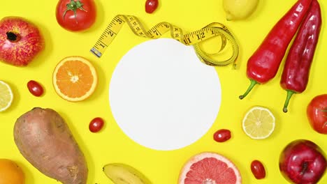 red diet healthy fruits and vegetables appear on yellow copy space background. stop motion flat lay