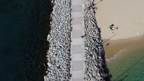 a view of the boardwalk and beach of the cabo san lucas marina pier