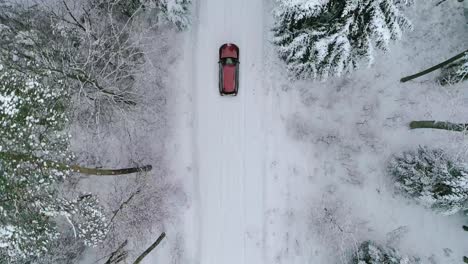 aerial view of car on road in beautiful winter scenery