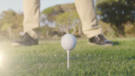 Animation-of-light-trails-over-senior-caucasian-man-playing-golf-on-golf-course