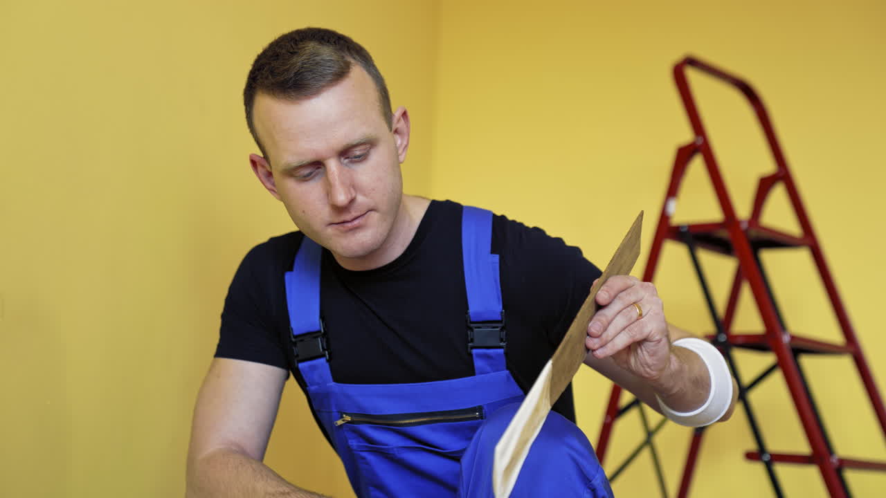 Professional man painting wall. Painter man at work painting wall with roller