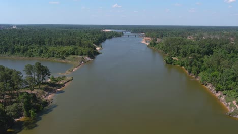 aerial of cars driving on bridge that crosses over the san jacinto river in houston, texas