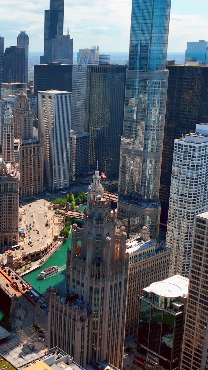 Glass skyscrapers on the banks of the river in the center of the city of Chicago. Aerial view. Vertical video