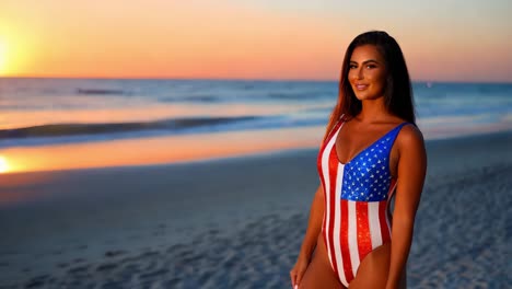 woman in american flag swimsuit at sunrise beach