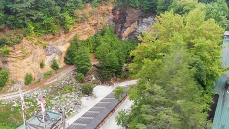 4k drone video of gem mine at emerald village near little switzerland, nc on summer day