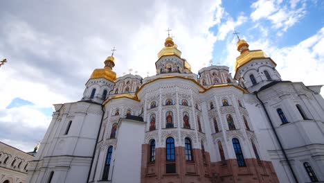 white and brick kiev pechersk lavra church cathedral with golden domes, saints apostles, pan upwards, kyiv ukraine