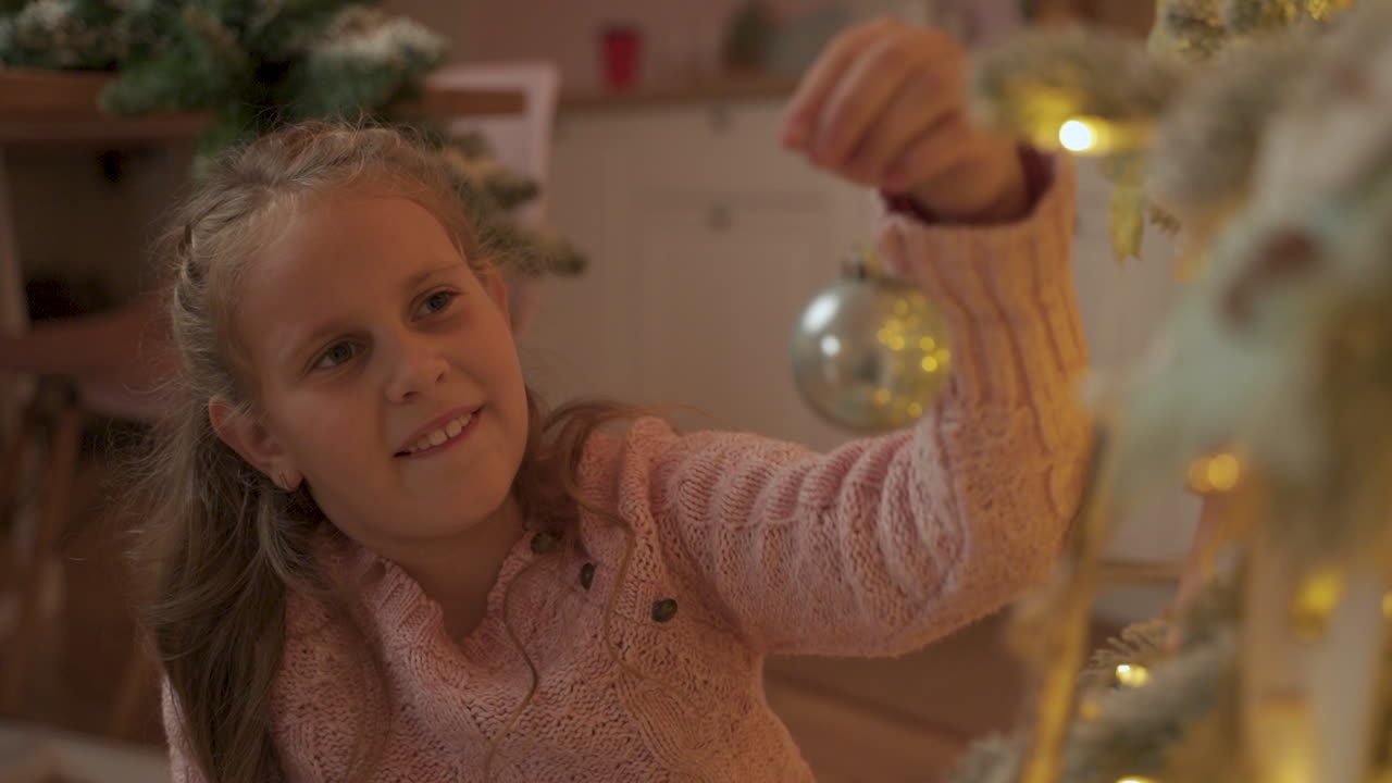 Little Girl Decorates The Christmas Tree With Balls At Home