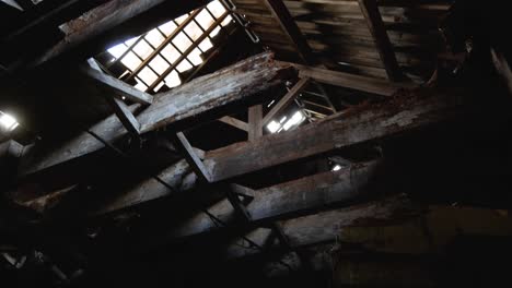 creepy shot of the exposed roof beams in an abandoned barn