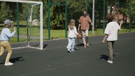 family fun: playing soccer and sharing hugs on an outdoor court