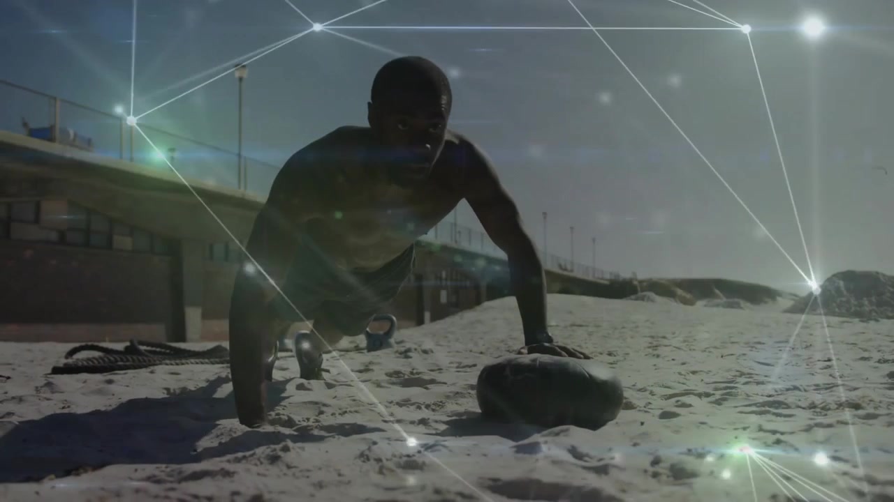 Fitness enthusiast using sandbag starting one-arm push-ups on pier beach with digital overlay