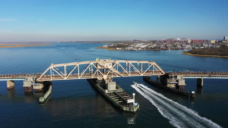 a aerial shot of a swing bridge opening on a bay in queens, ny