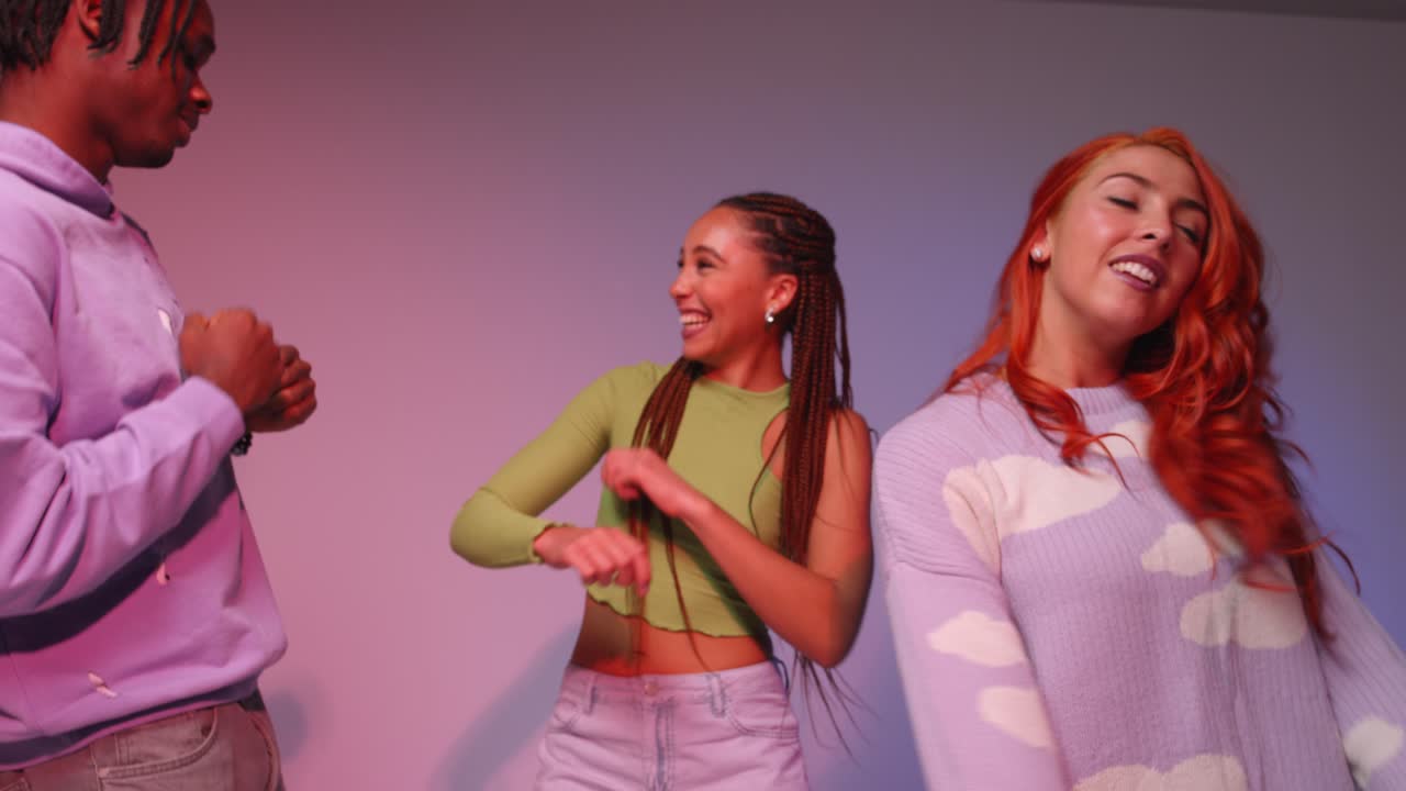 Studio Shot Of Young Gen Z Friends Dancing At Club Against Pink Background 5