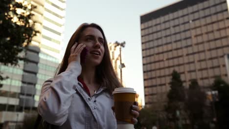 woman using smartphone on city street