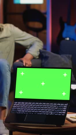 vertical video black young relaxed person having green screen in his trendy loft