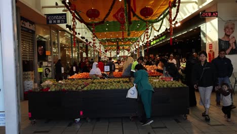 shoppers at a vibrant fruit and vegetable market