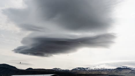 heavy mysterious dark clouds time lapse on white sky above glacier