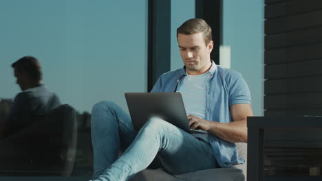 Casual-businessman-closing-notebook.-Closeup-modern-man-working-on-laptop