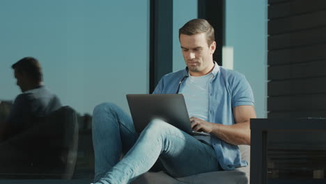casual businessman closing notebook. closeup modern man working on laptop