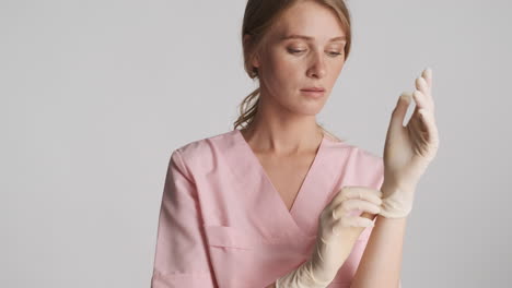 caucasian female doctor wearing medical gloves.