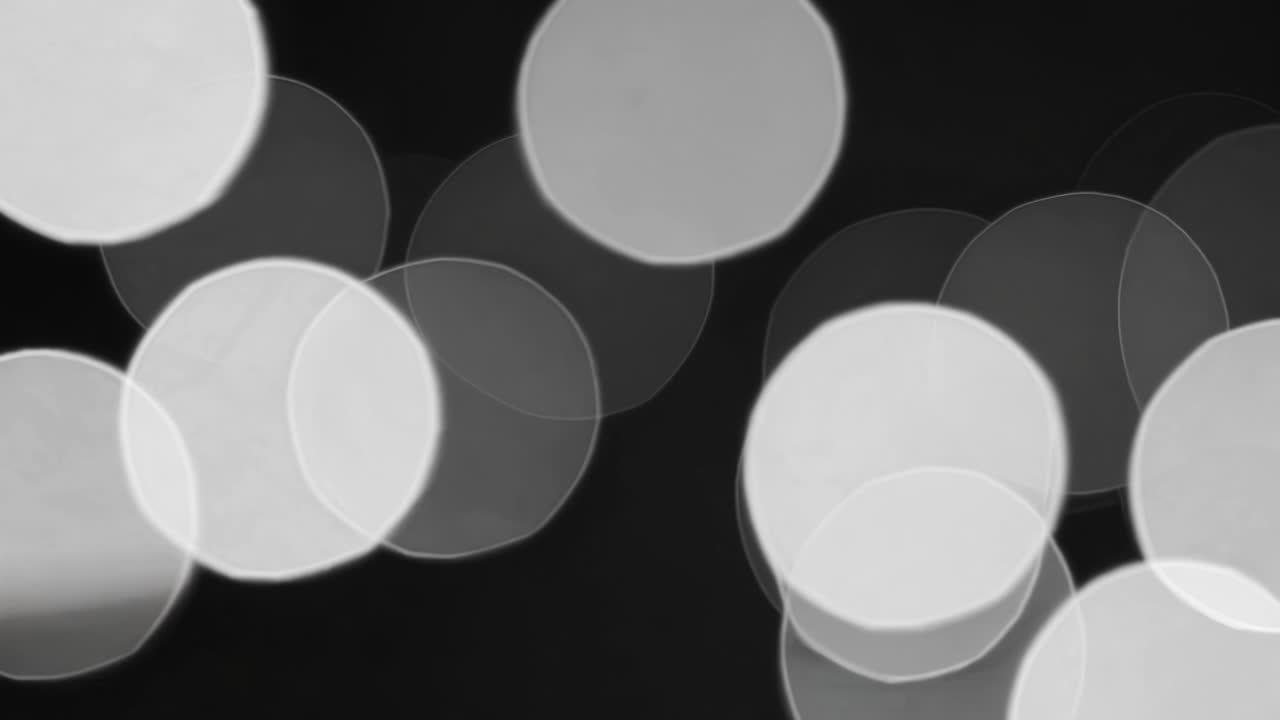 Abstract video concept with a bokeh effect in black and white