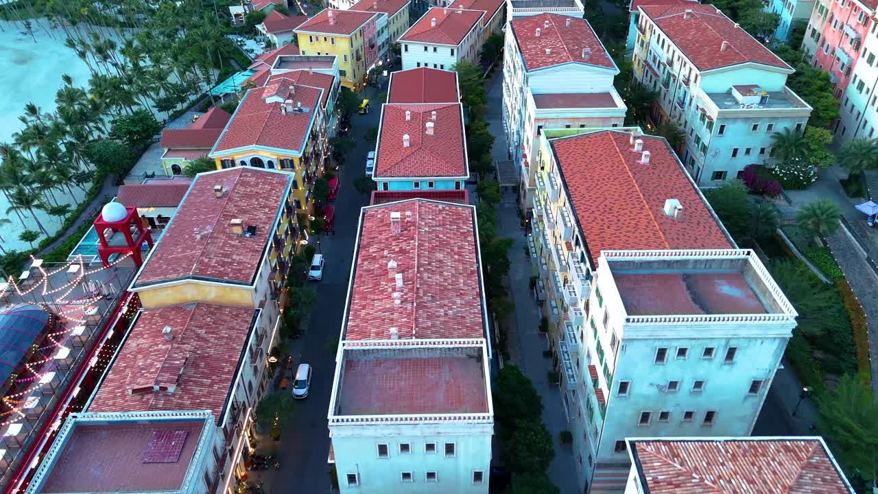 Aerial: Sunset Town fake Italian city buildings during the day in Phu Quoc Island, Vietnam, push-in drone shot