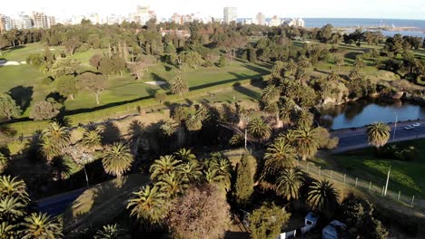 aerial view of the park, a road with cars passing and the sea in the background