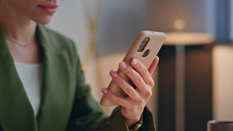 woman hands scrolling mobile phone sitting office closeup. lady swiping screen