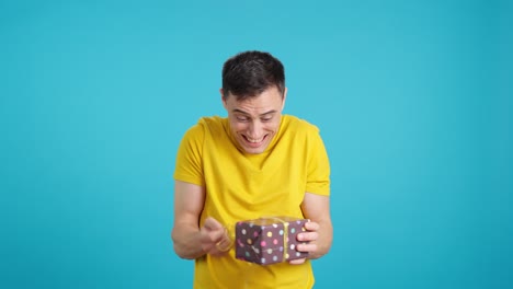 man opening a gift box with excitement