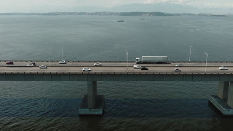 Aerial-top-down-view-car-and-trucks-drive-on-Rio-Niteroi-Sea-crossing-concrete-bridge