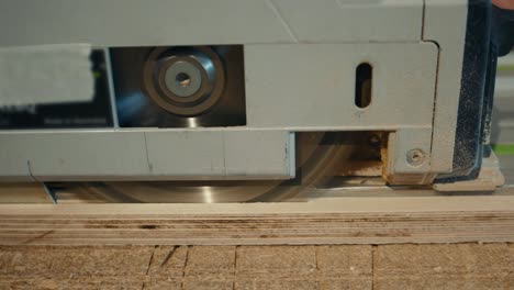 cerca de las manos del carpintero cortando madera con la sierra de mesa en el taller, muebles de artesano