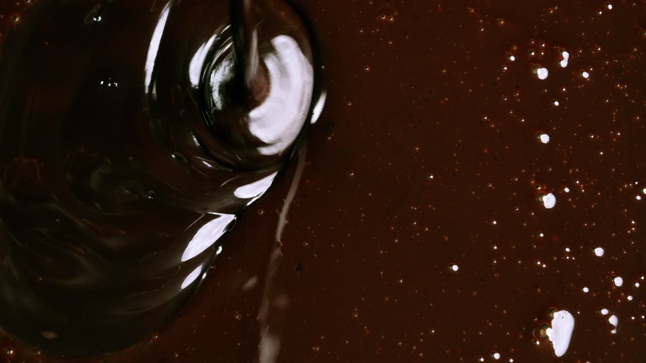 Pouring chocolate on chocolate from a bird's eye view